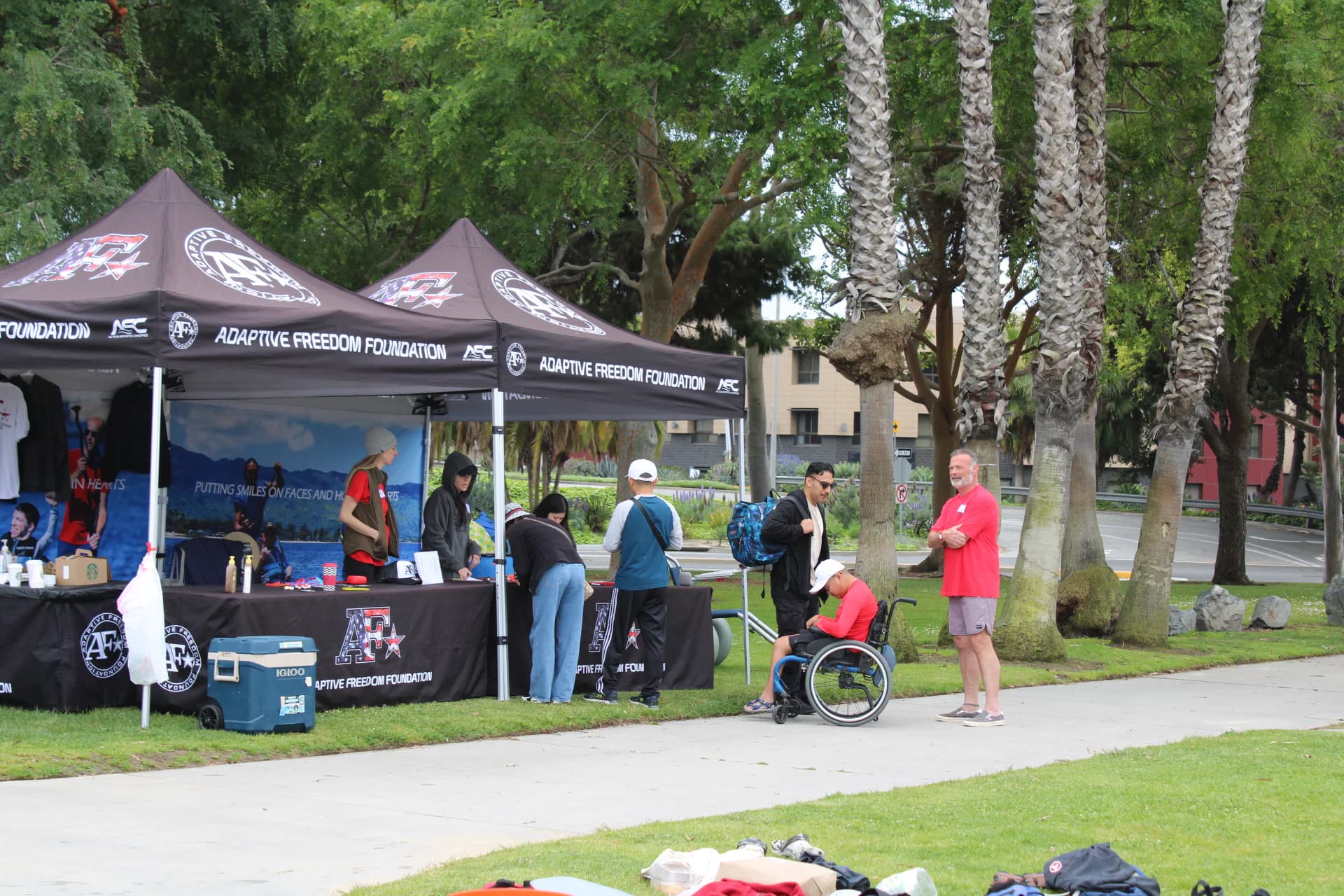 AFF community members gathered beneath event tents by the shoreline