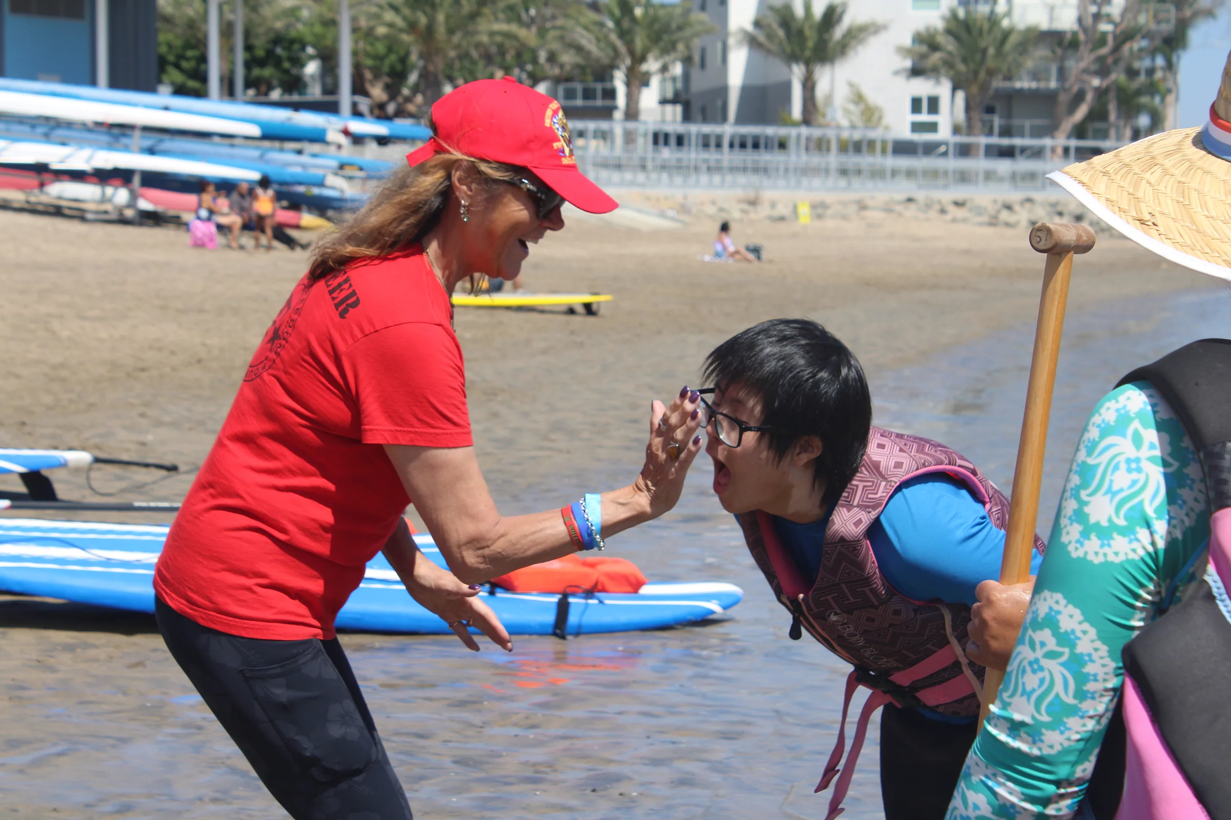 A participant and AFF volunteer celebrating a successful paddle with a high five