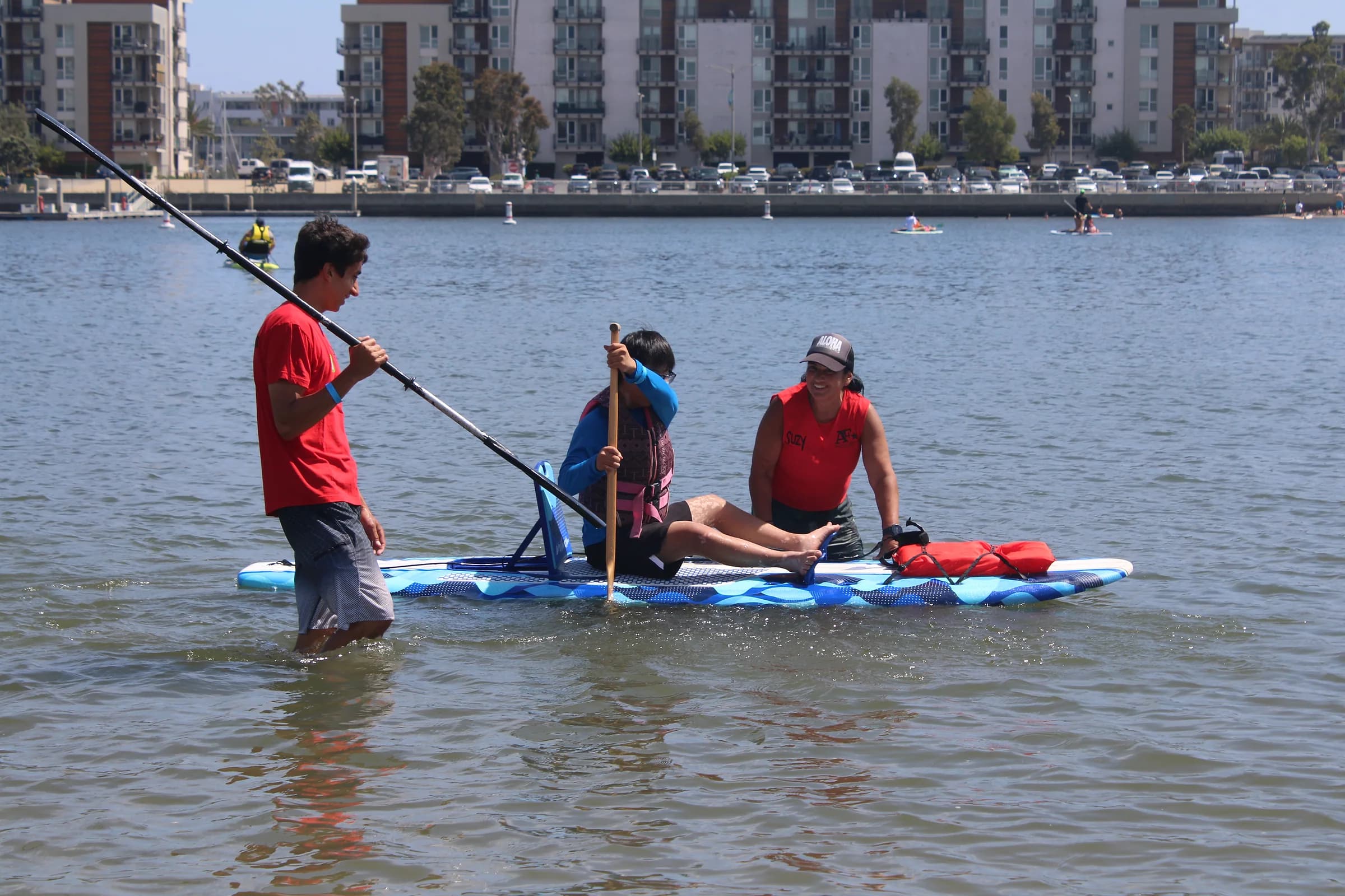 Two AFF volunteers supporting a participant during an on-water launch