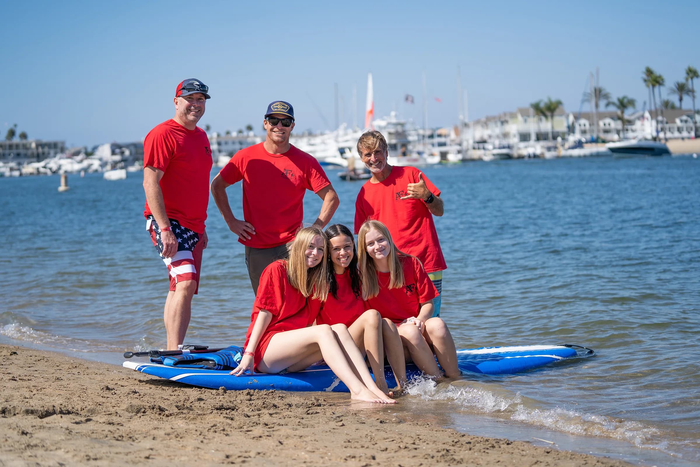 AFF volunteers gathered with paddleboards beside the Long Beach marina